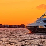 Yachtig on open sea at golden sunset panoramic view