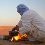 Native arab bedouin making a dinner in the desert