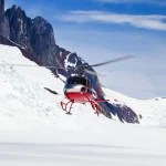 rescue helicopter landing on a glacier scaled