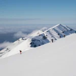 skiers on snowy mountain slope scaled