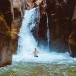 Man relaxing under waterfall, Jorda. wadi mujib
