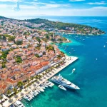 Town of Hvar bay and yachting harbor aerial view